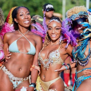 A group of women in colorful bikinis posing for a photo.