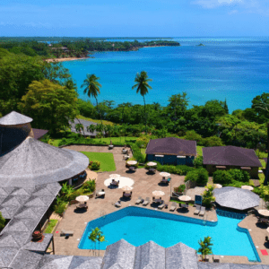 An aerial view of a resort surrounded by the ocean.