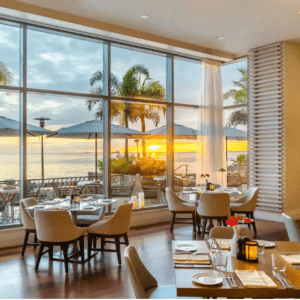 A restaurant with large windows overlooking the ocean.