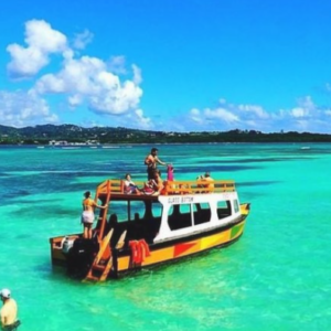 A boat is floating in the clear blue water.