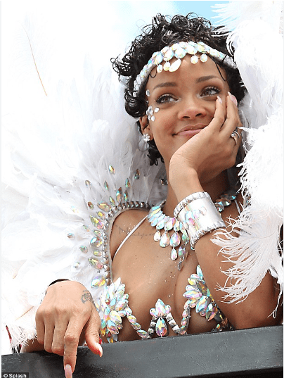 Woman in white carnival costume smiling.