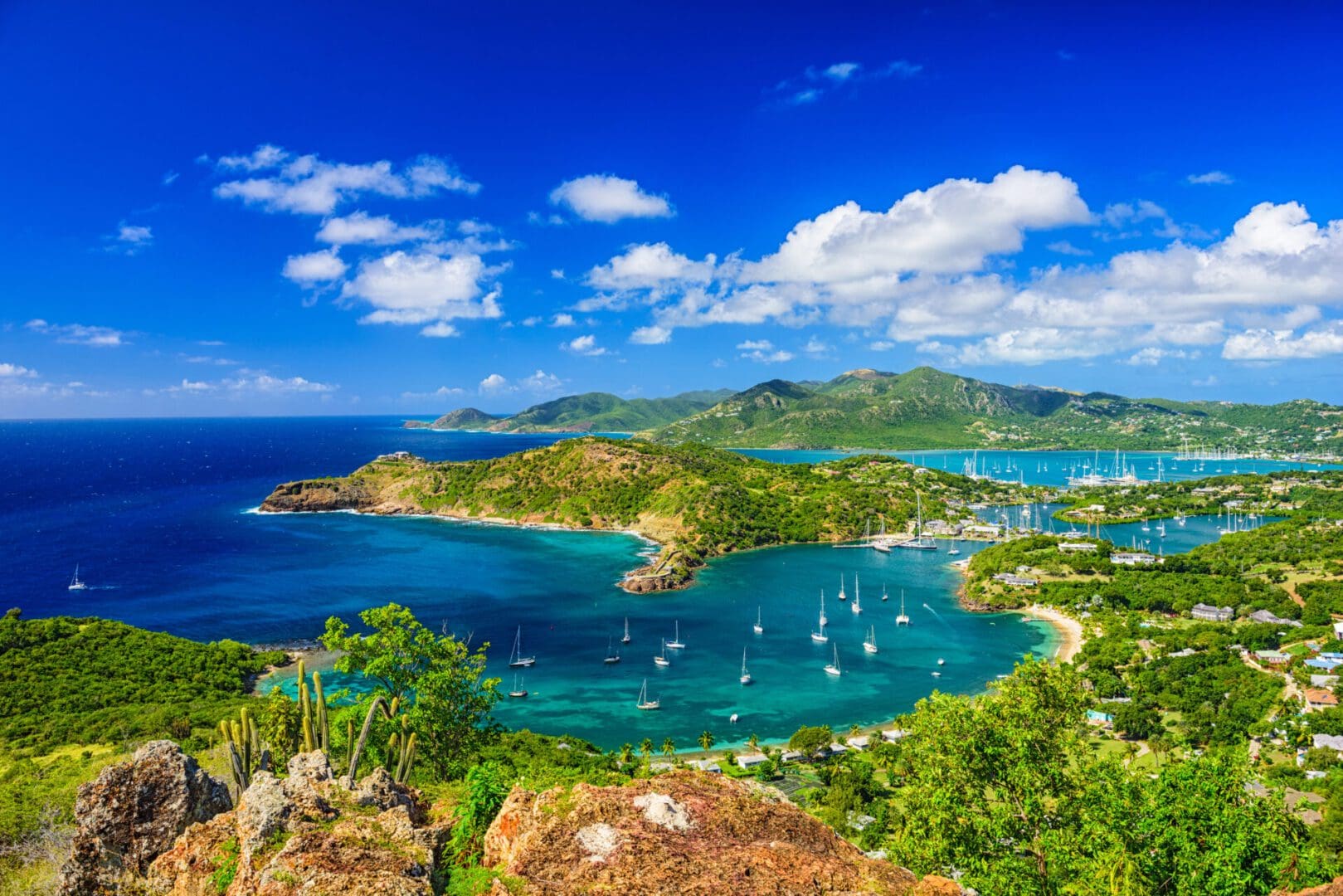 Aerial view of a tropical island with boats.