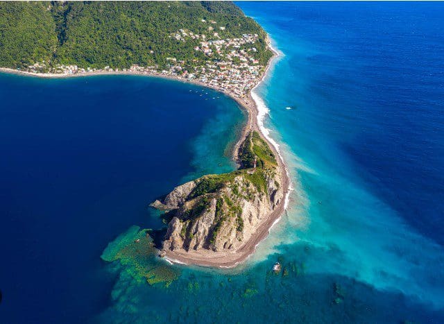 Aerial view of a small island with a beach.