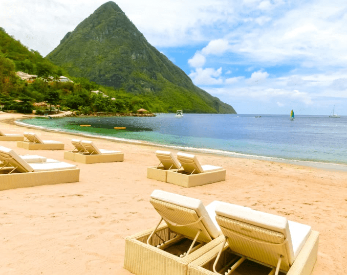 Beach chairs on a white sand beach.