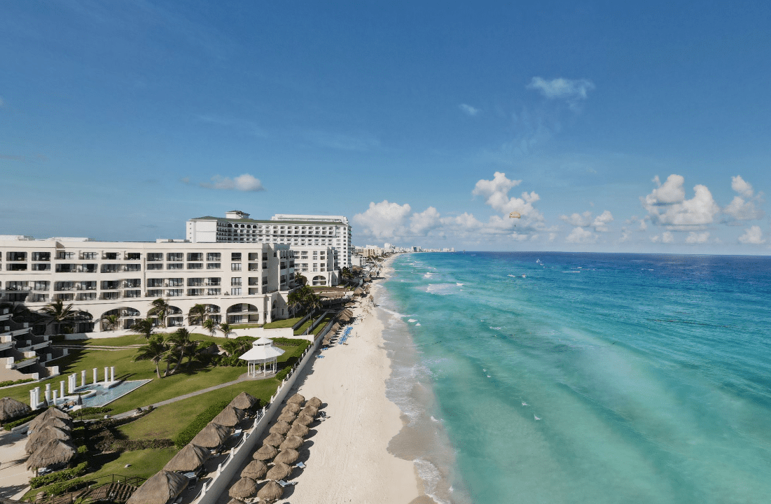 Beachfront hotel with clear turquoise water.