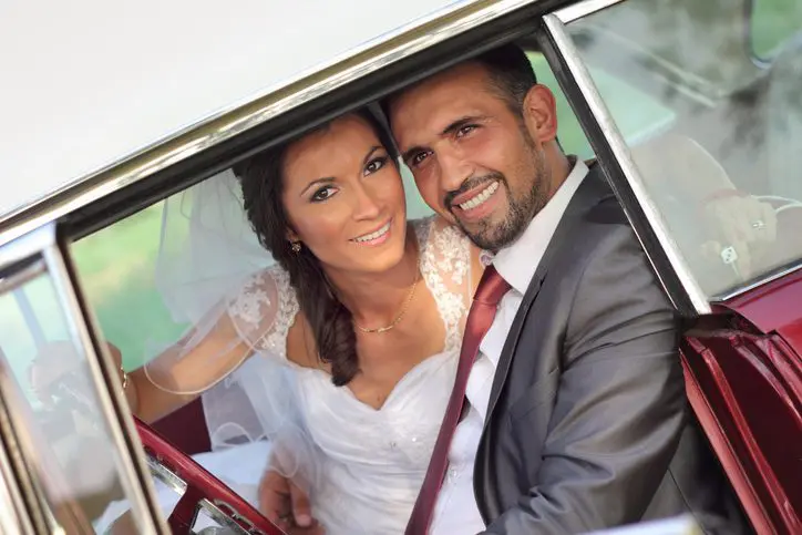 Bride and groom in a vintage car