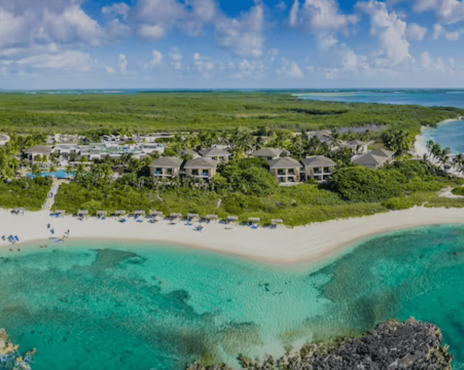 Aerial view of resort on a beach.