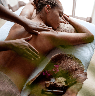 Woman receiving a back massage on a spa table.