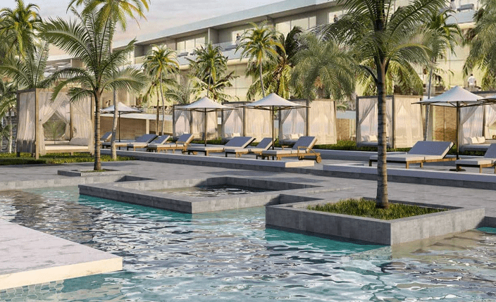 Resort pool with lounge chairs and cabanas.