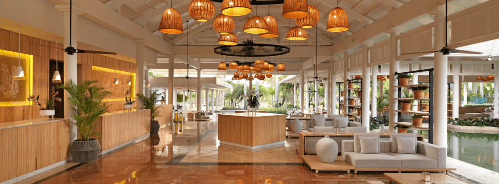 Hotel lobby with wicker lamps and pool.