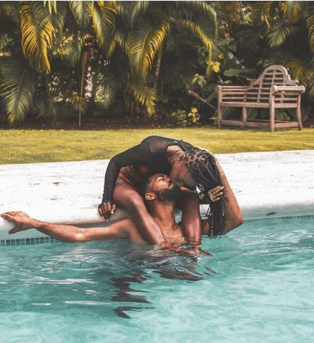 Couple kissing in a swimming pool.