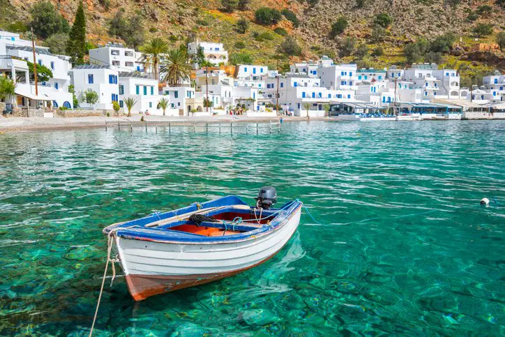 A small boat in clear turquoise water.