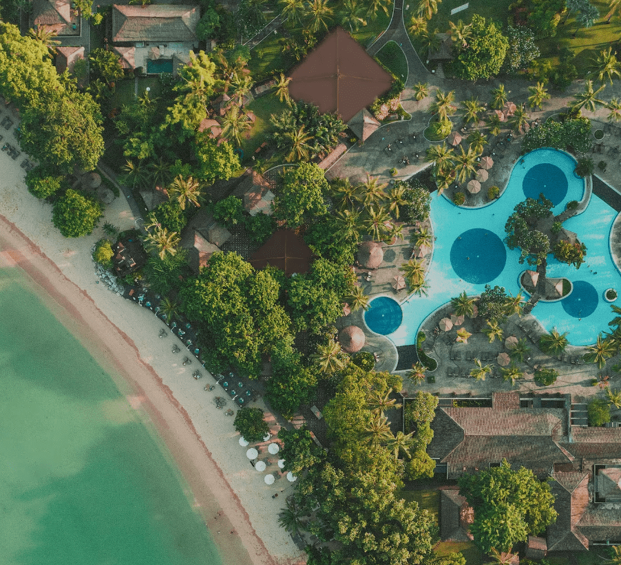 Tropical resort with beach and pool.