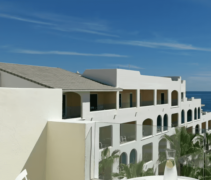 White building with arched windows and balconies.