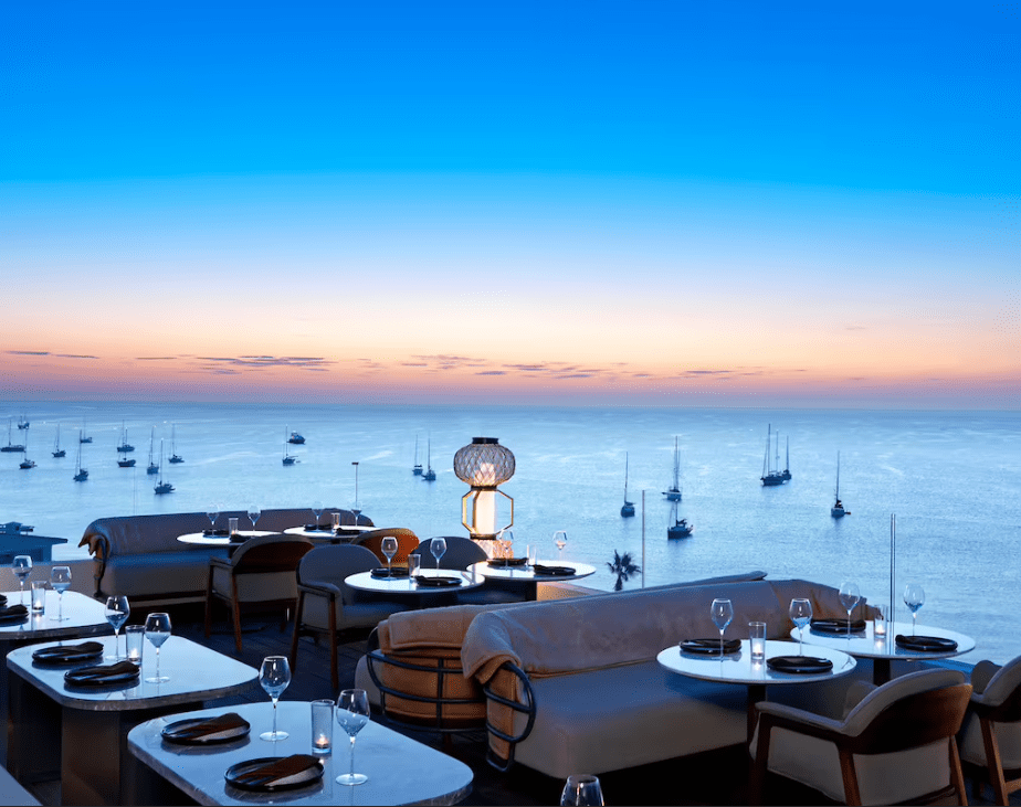 Sunset ocean view rooftop dining.