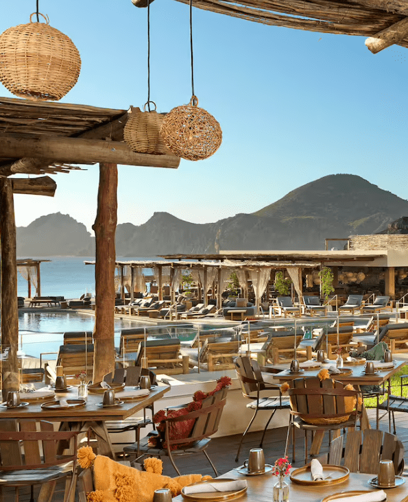 Outdoor dining with ocean view and pool.