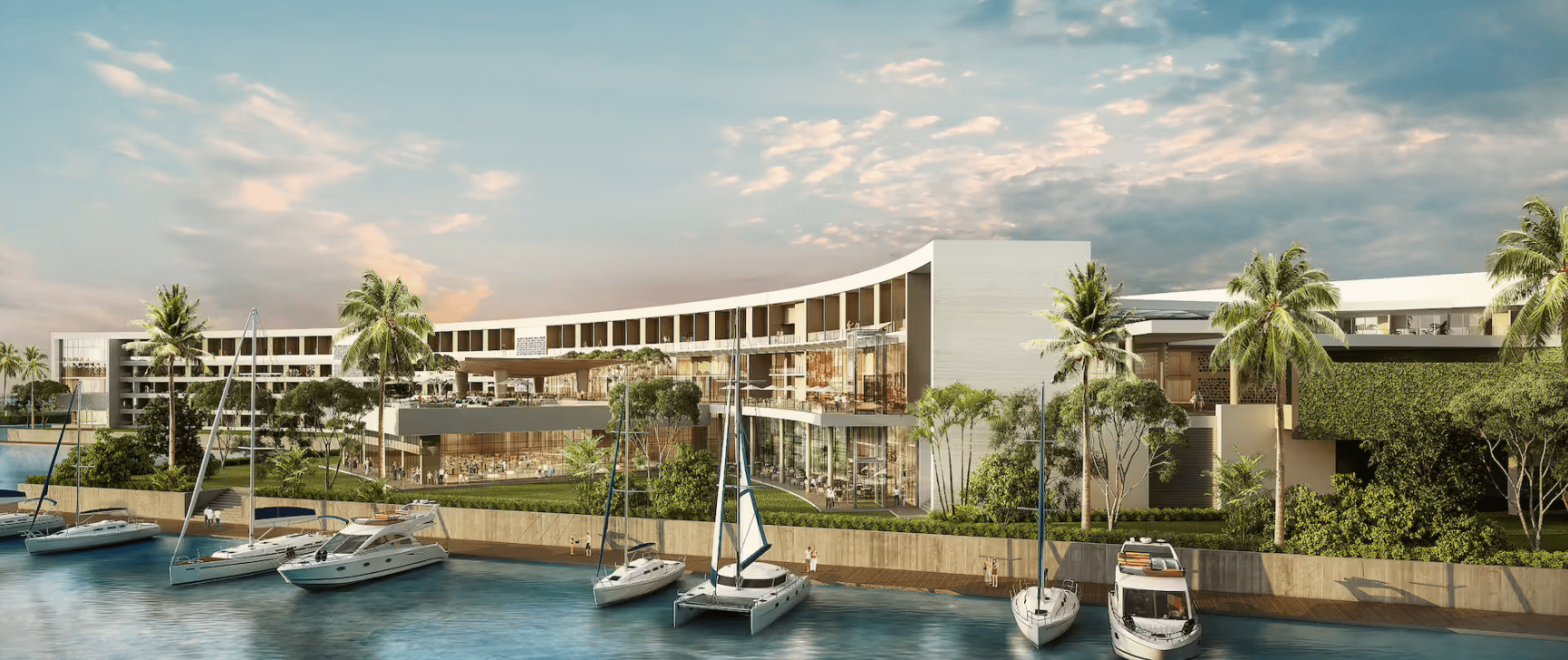 Modern resort with boats and palm trees.