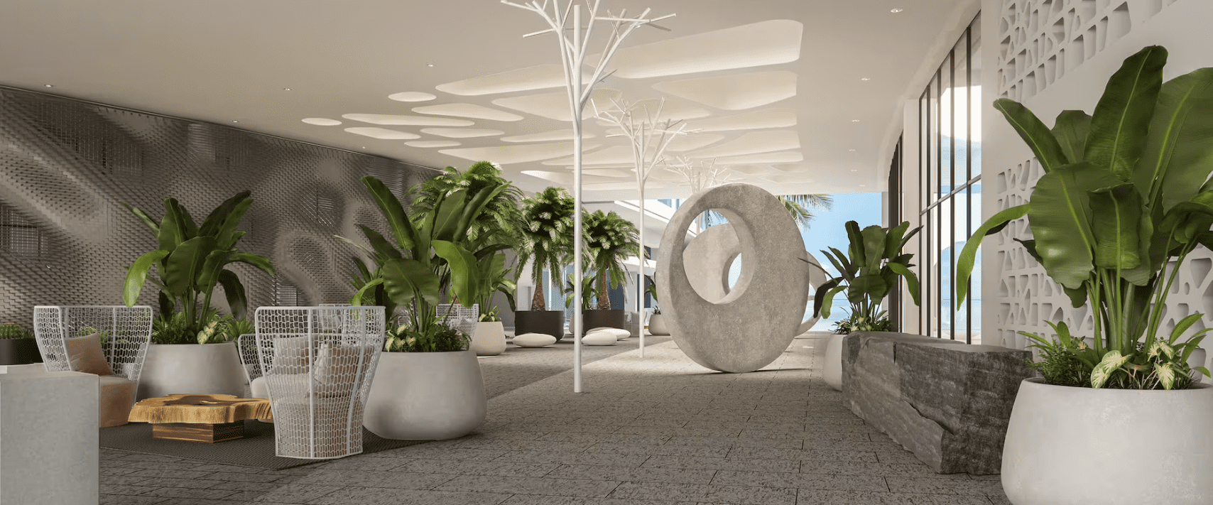 Modern lobby with plants and sculpture.