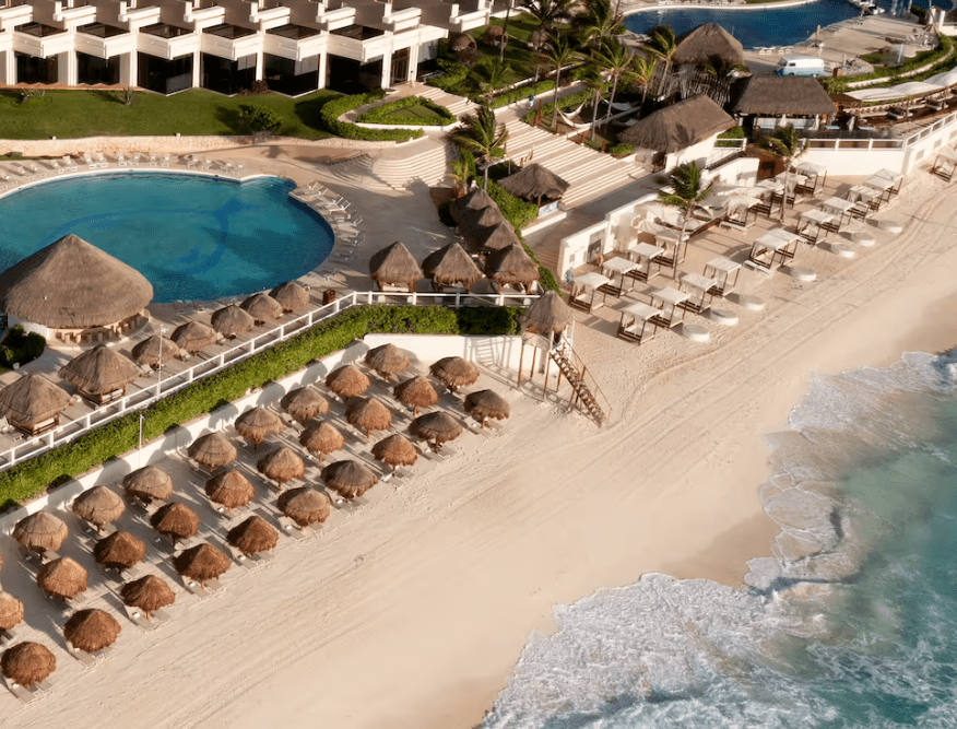 Aerial view of resort beach with pool.