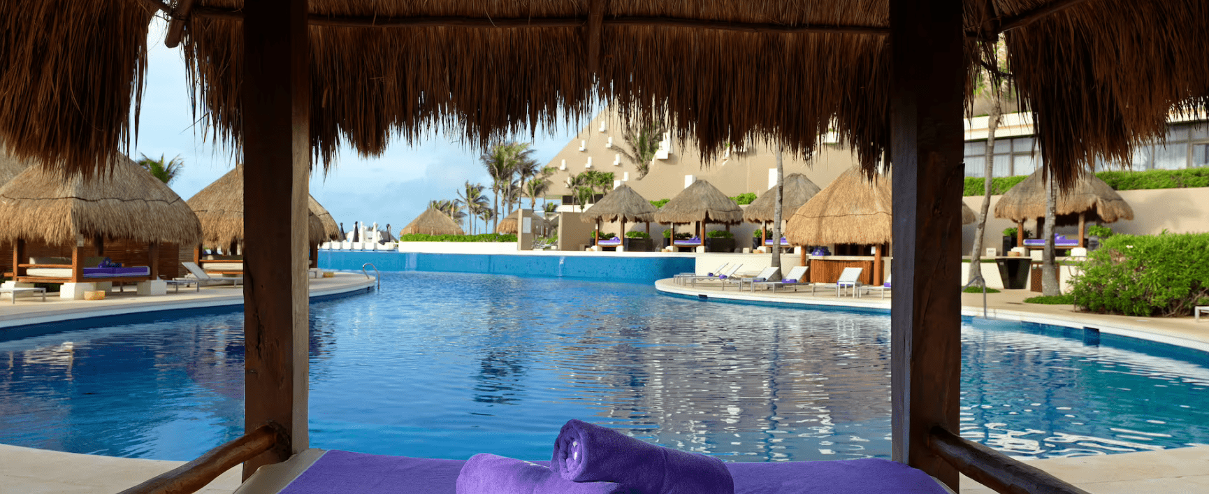 Pool view from a thatched hut.