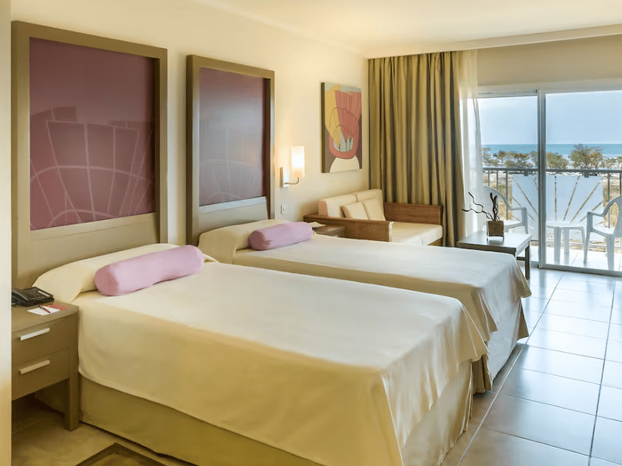 Hotel room with two beds and ocean view.