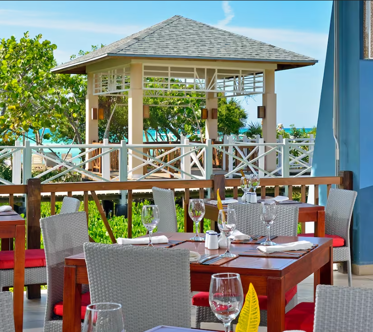 Outdoor dining with ocean view and gazebo.