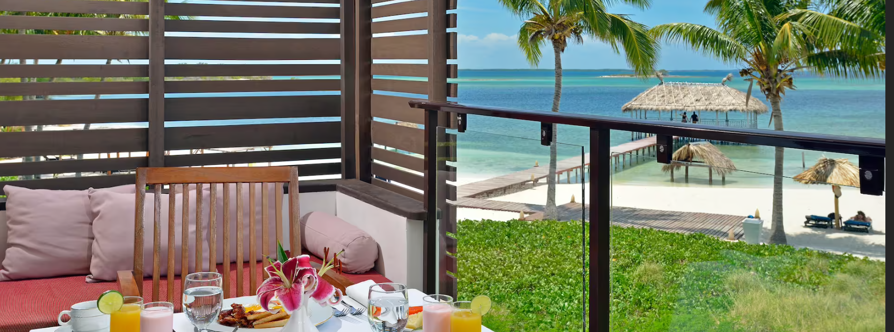 Ocean view balcony breakfast with flowers.