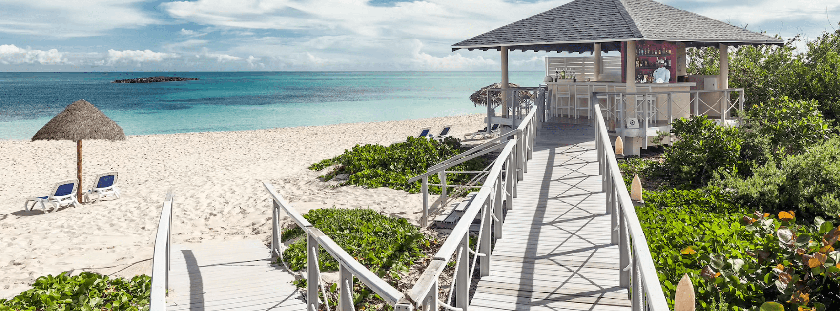 Beach bar with walkway and ocean view.