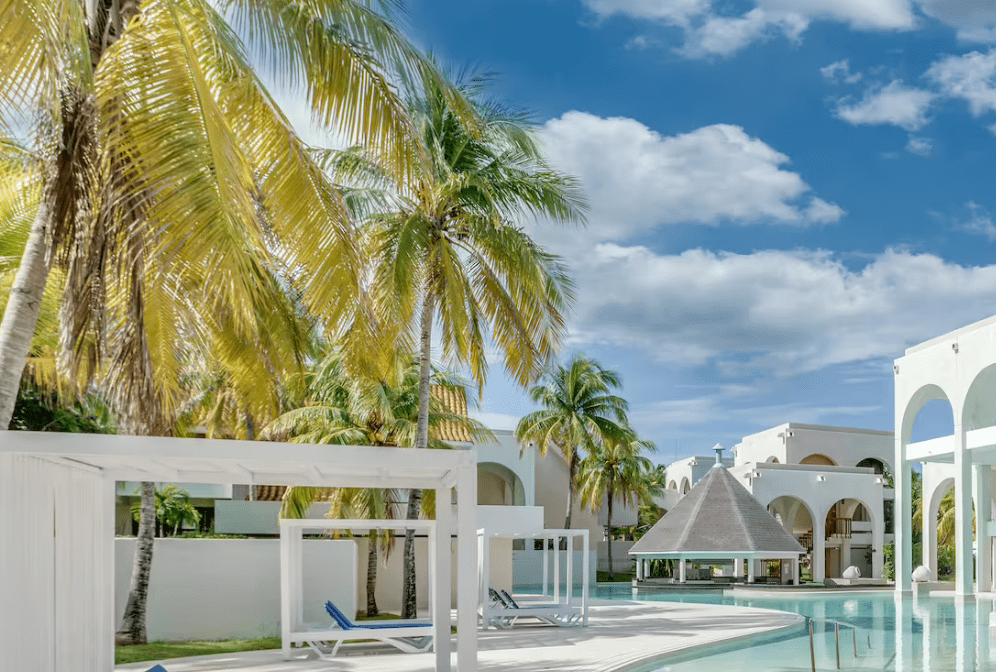 Palm trees and swimming pool at resort.