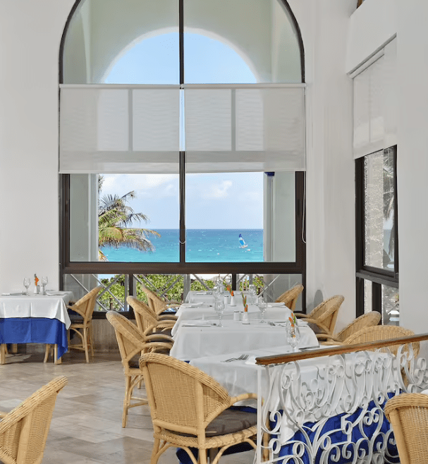 Ocean view restaurant with wicker chairs.