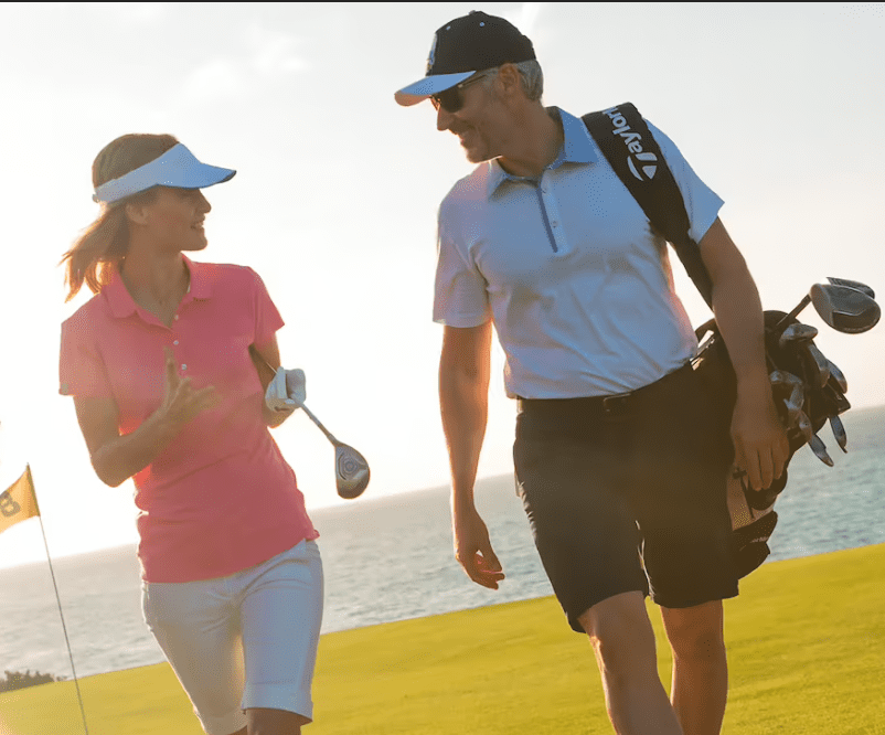 Couple walking on a golf course.