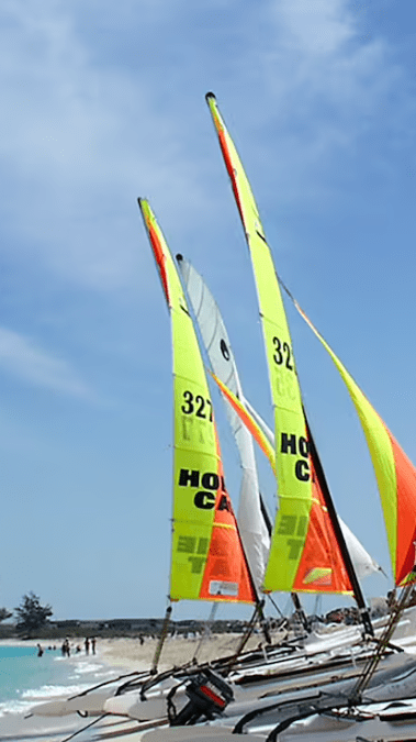 Colorful sailboats on a beach.