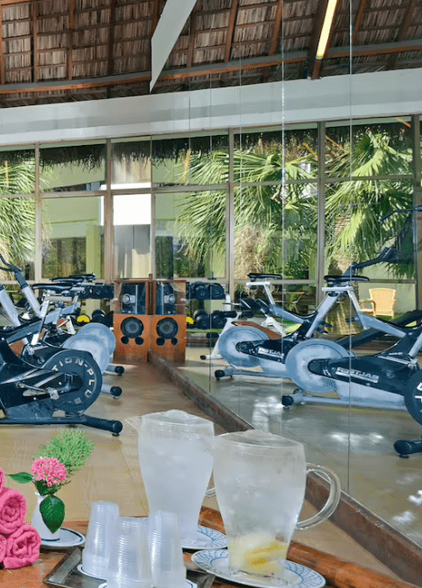 Indoor gym with stationary bikes and drinks.