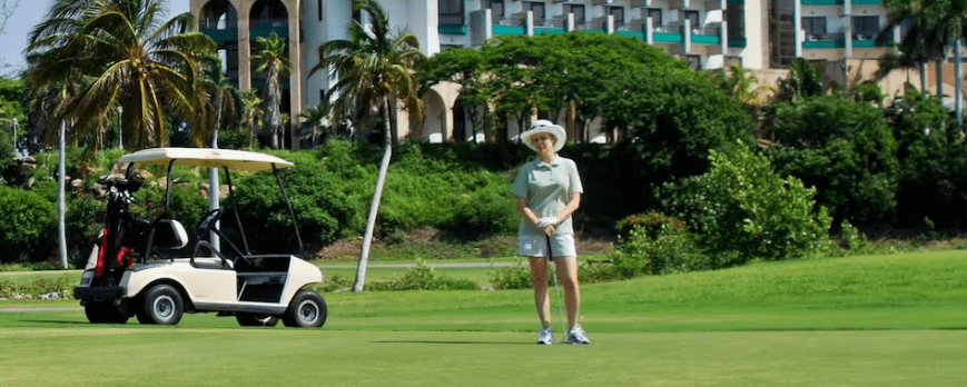 Woman playing golf on a green course.