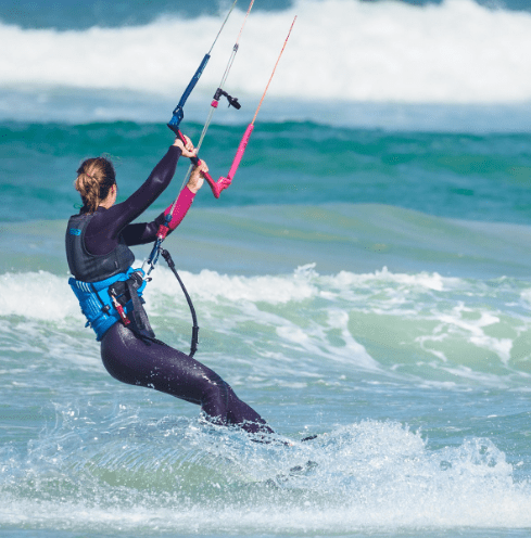 Woman kitesurfing on a windy day.