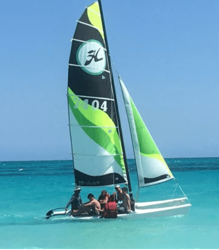 Catamaran sailing in turquoise water.