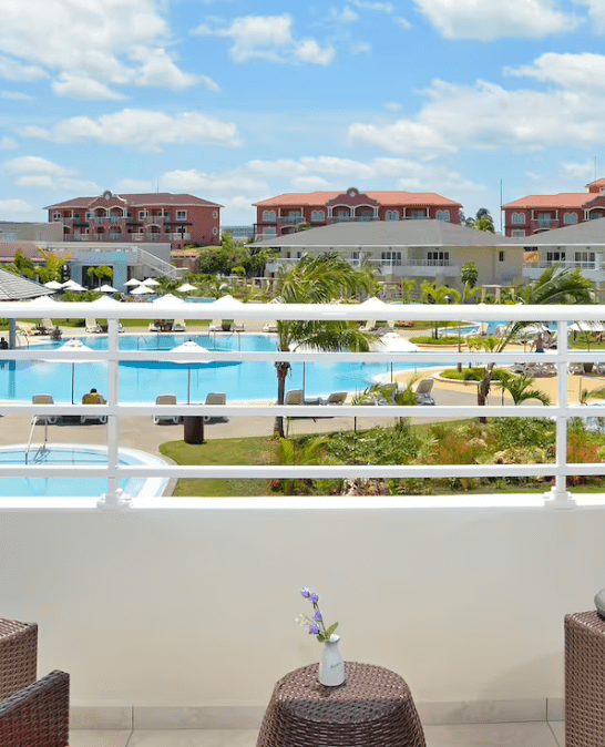 Balcony view of resort pool and buildings.