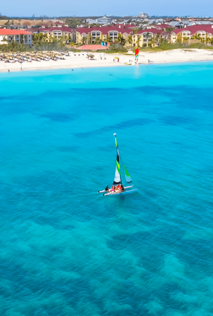 Sailboat on turquoise ocean water.