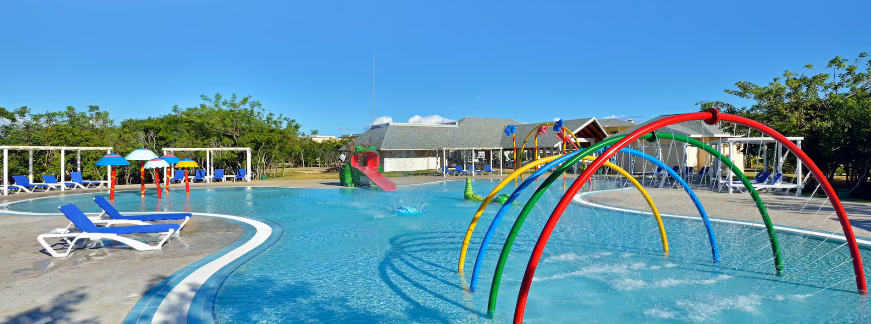 Colorful pool with water arches and slides.