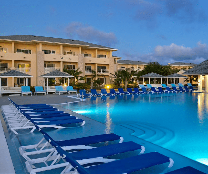 Resort pool with blue lounge chairs.