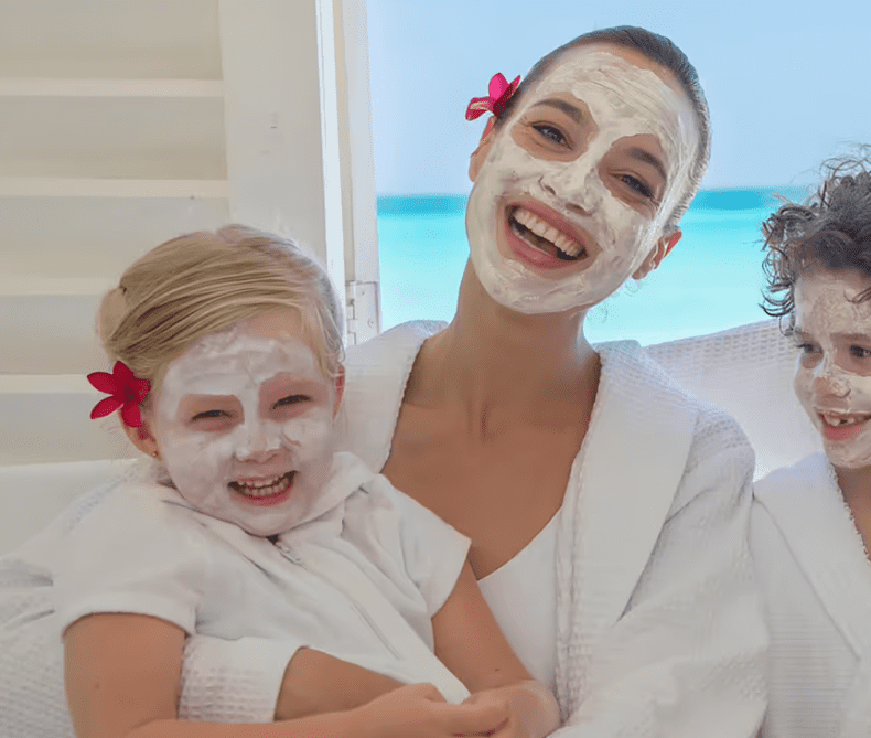 Family wearing face masks and smiling.