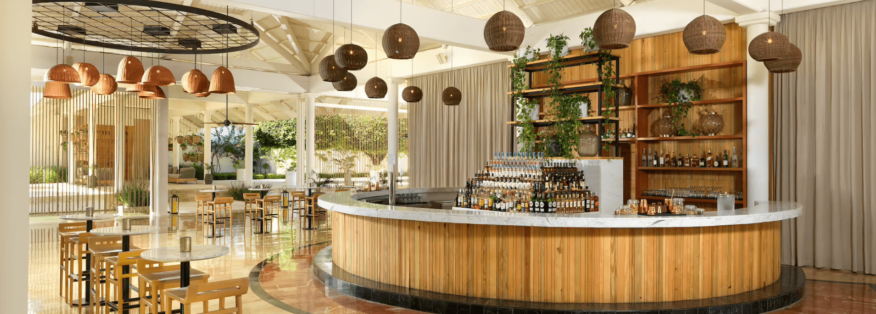 Modern bar with wooden accents and wicker lights.