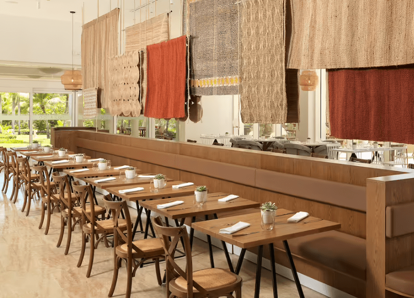 Long wooden dining table with chairs.