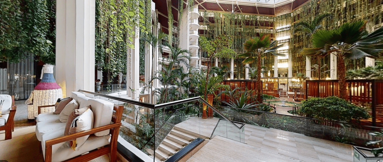 Indoor seating area overlooking a lush atrium.