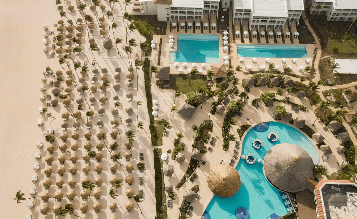 Aerial view of a beach resort with many palm trees.