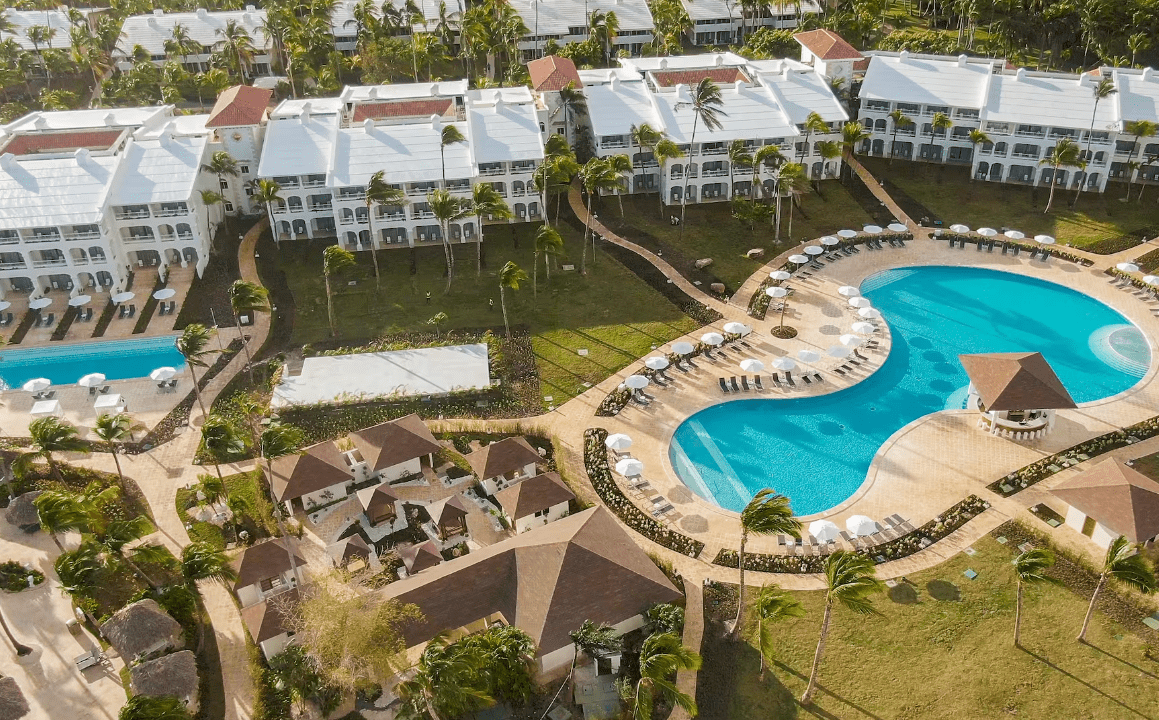 Aerial view of a tropical resort with a pool.