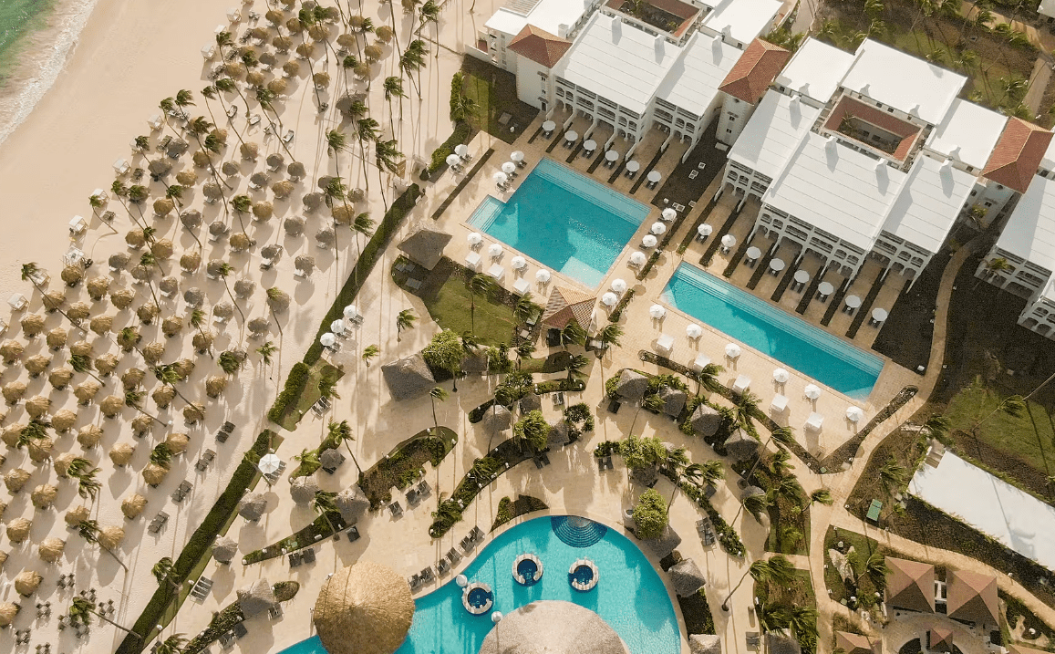 Aerial view of a beach resort with many palm trees.