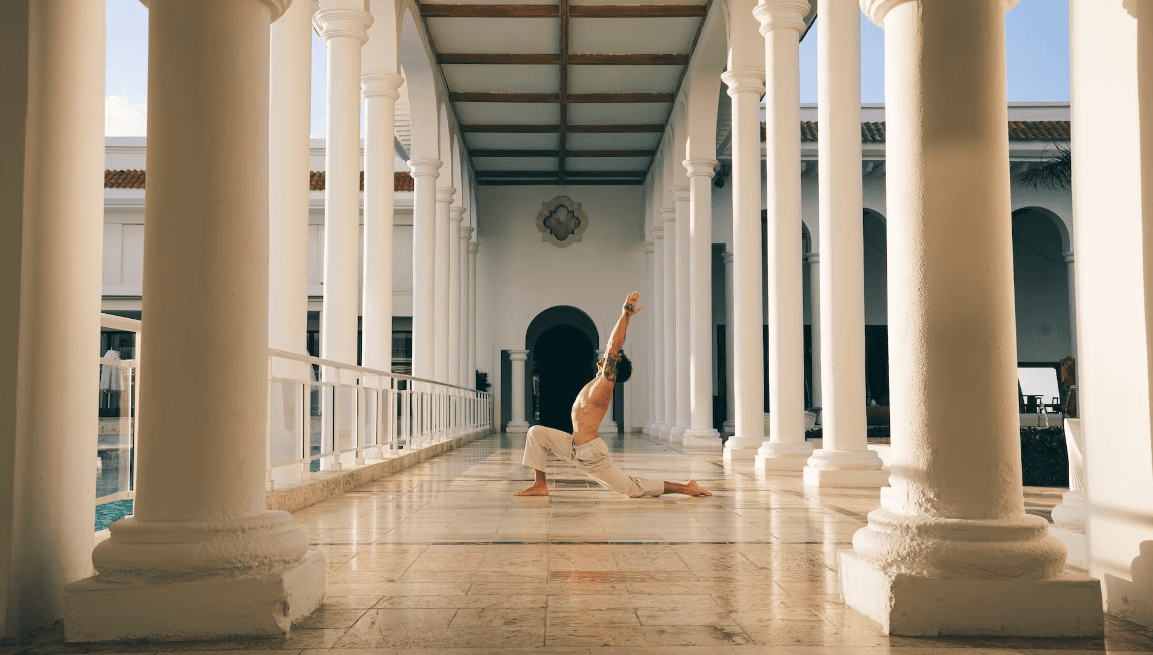 Man doing yoga in a hallway.