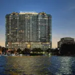 Four Seasons Hotel illuminated at dusk.