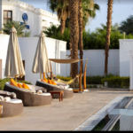 Resort poolside lounge chairs and a pool.